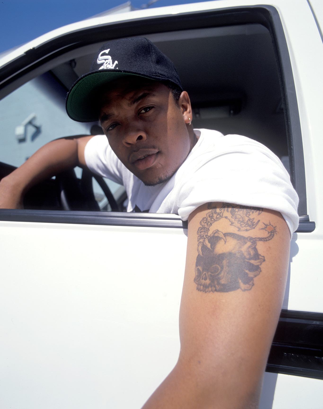 Los Angeles, CA- 1993: Dr. Dre showing his tattoo in 1993. At the time Dre was in the studio with Snoop Doggy Dogg and the Dogg Pound recording Doggystyle. This photo is from the Defining Years of Hip-Hop 1990-2000 (Photo by Chi Modu/diverseimages)