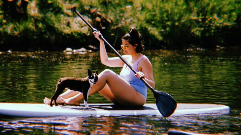 Emma Breschi Model Interview - Emma Breschi and her dog stand up paddle boarding